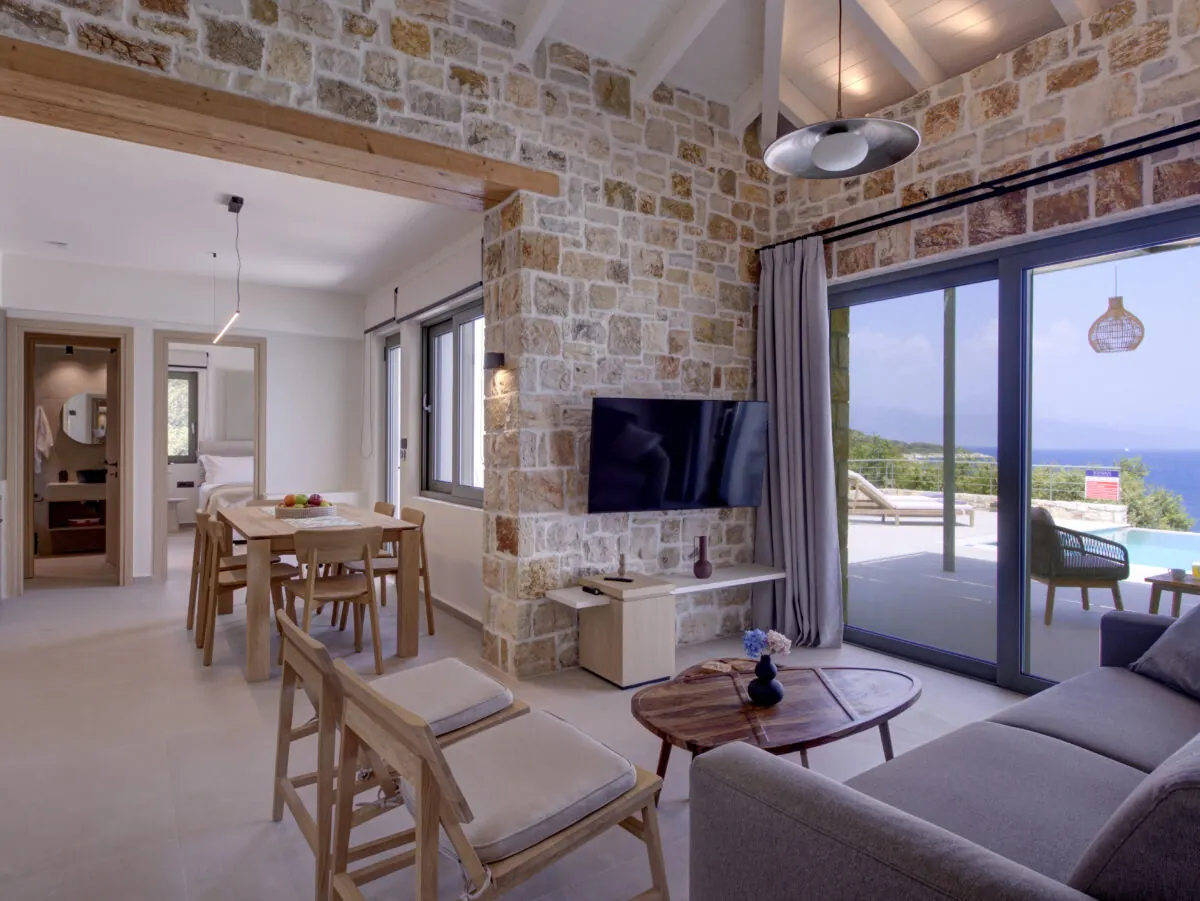 Stone living room at Alios opening to the pool