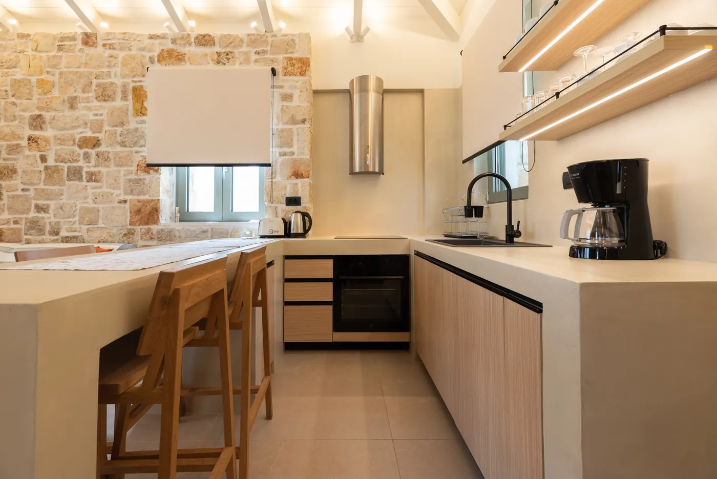 Warm minimal kitchen inside an Apílion villa